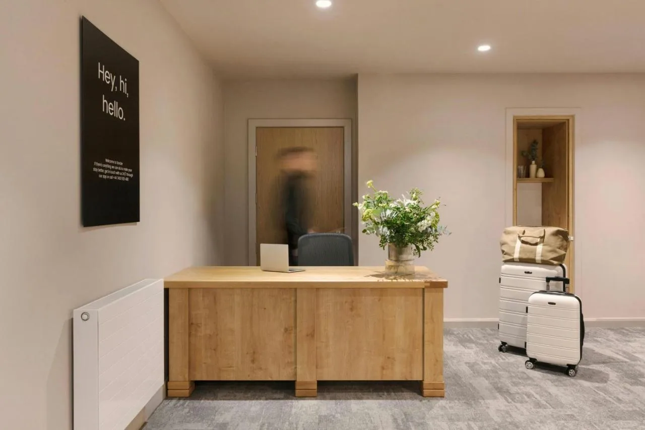 an office with a desk and a chair with flowers at VCity Suites at The Teacher in Glasgow