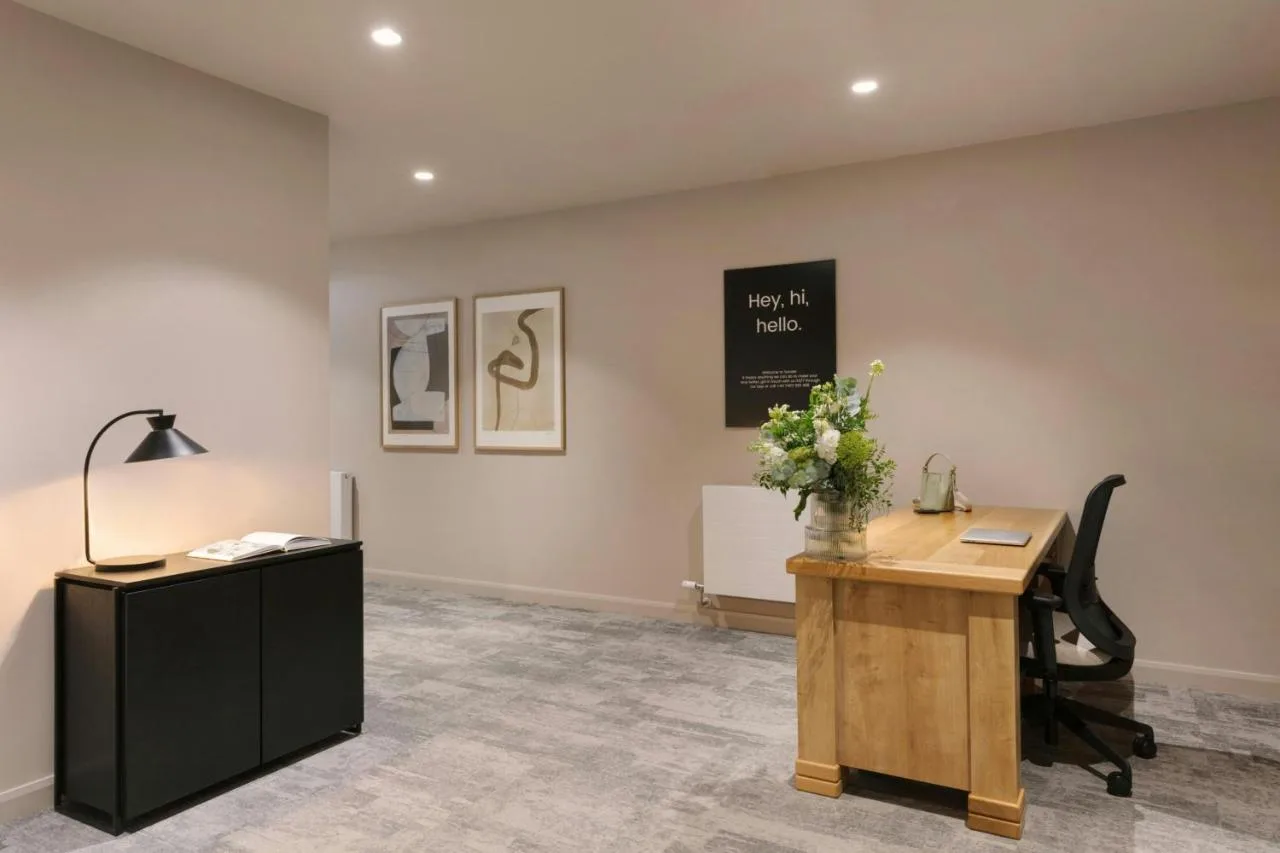 an office with a desk and a lamp on a wall at VCity Suites at The Teacher in Glasgow